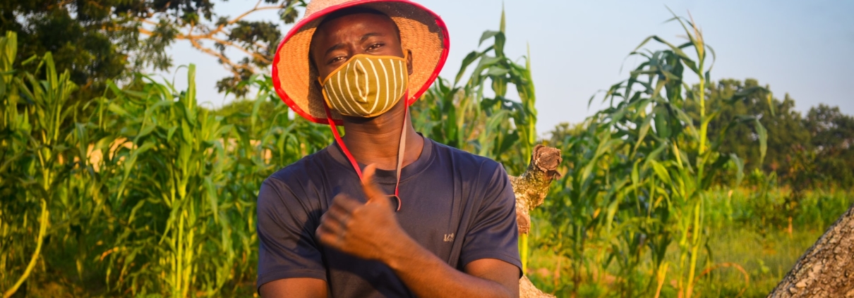 Farmer in a field wearing a mask